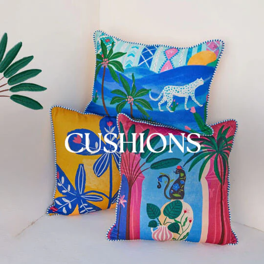A collection of colorful, patterned cushions arranged on a sofa.